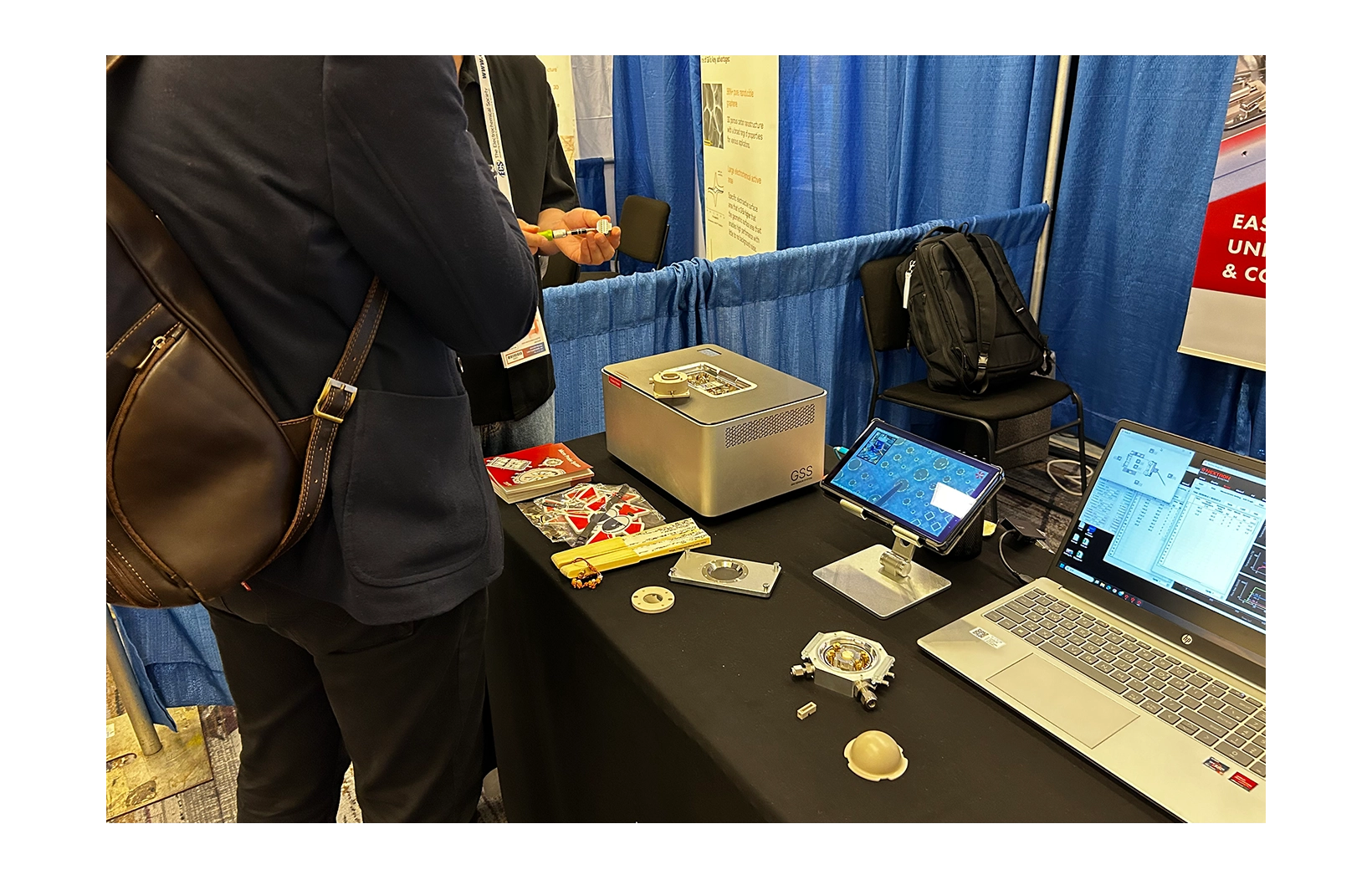 Customers viewing the Nextron booth at 2024 ECS